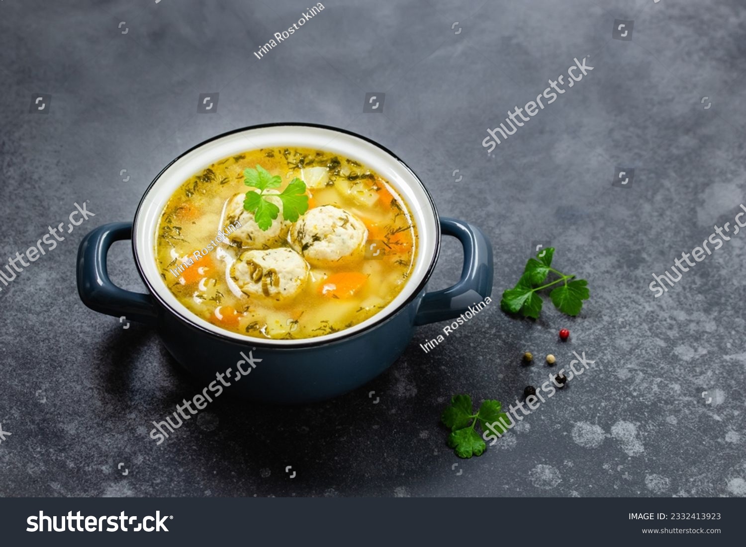 Summer low calorie meatball soup in pot on dark background. Top view, copy space, flat lay. #2332413923