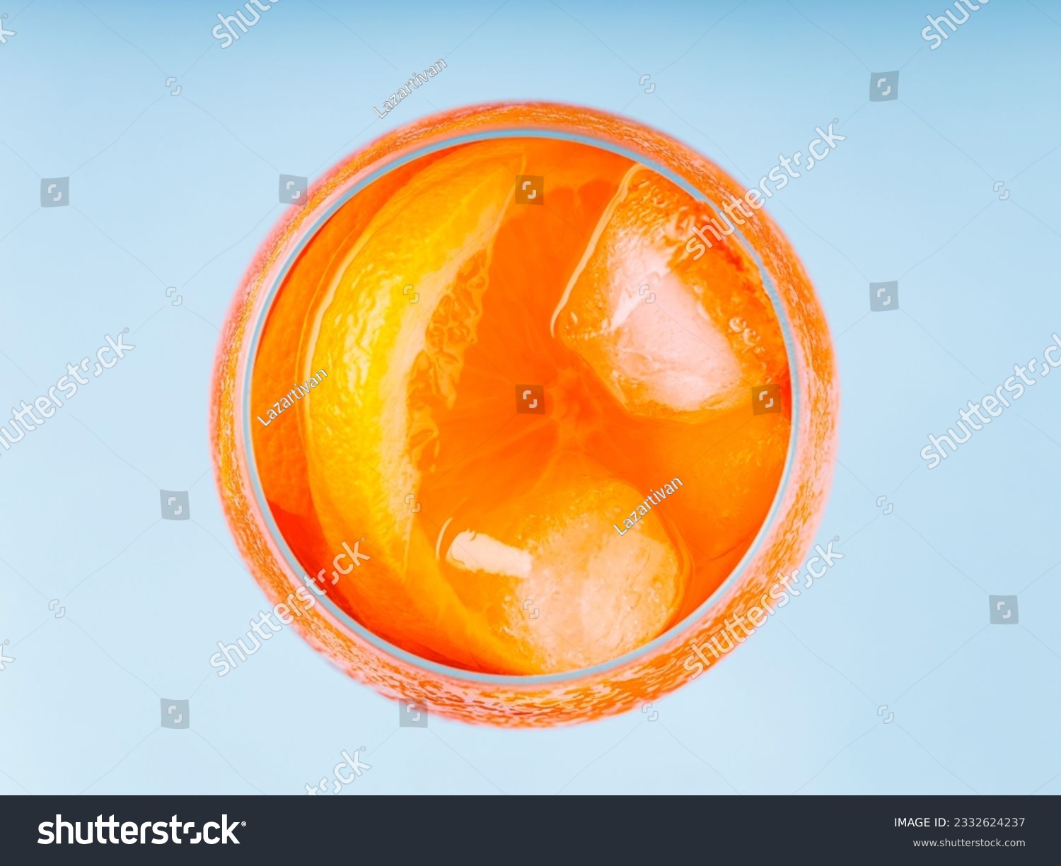 Aperol Spritz cocktail in glass on a blue background. Cocktail Aperol Spritz with orange slice and ice cubes. Top view #2332624237