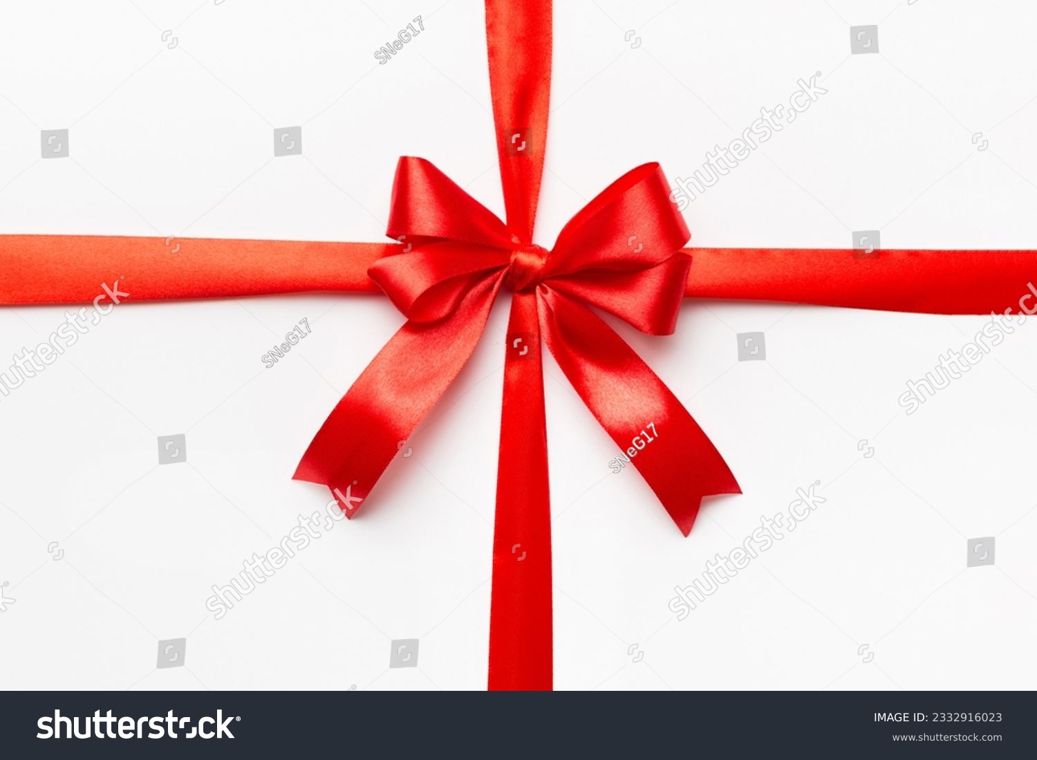 Top view of Red ribbon rolled and red bow isolated on colored background. Flat lay with copy space. #2332916023