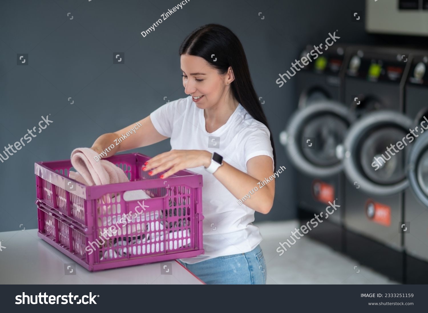 Woman in the public room to wash her cloths, self service commercial laundry and drying machine in a public room. #2333251159