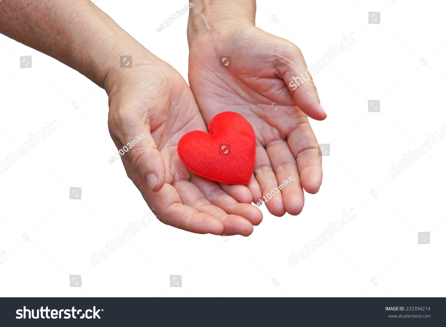 old hands of the elderly giving a red heart #233394214