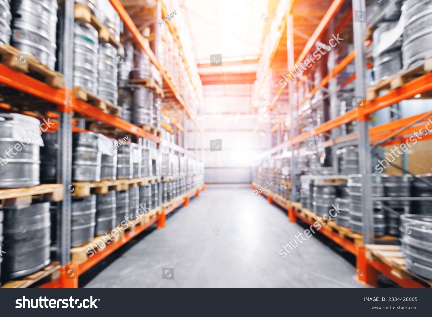 Beer kegs in warehouse of modern brewery stock, blurred background with sunlight. #2334428005