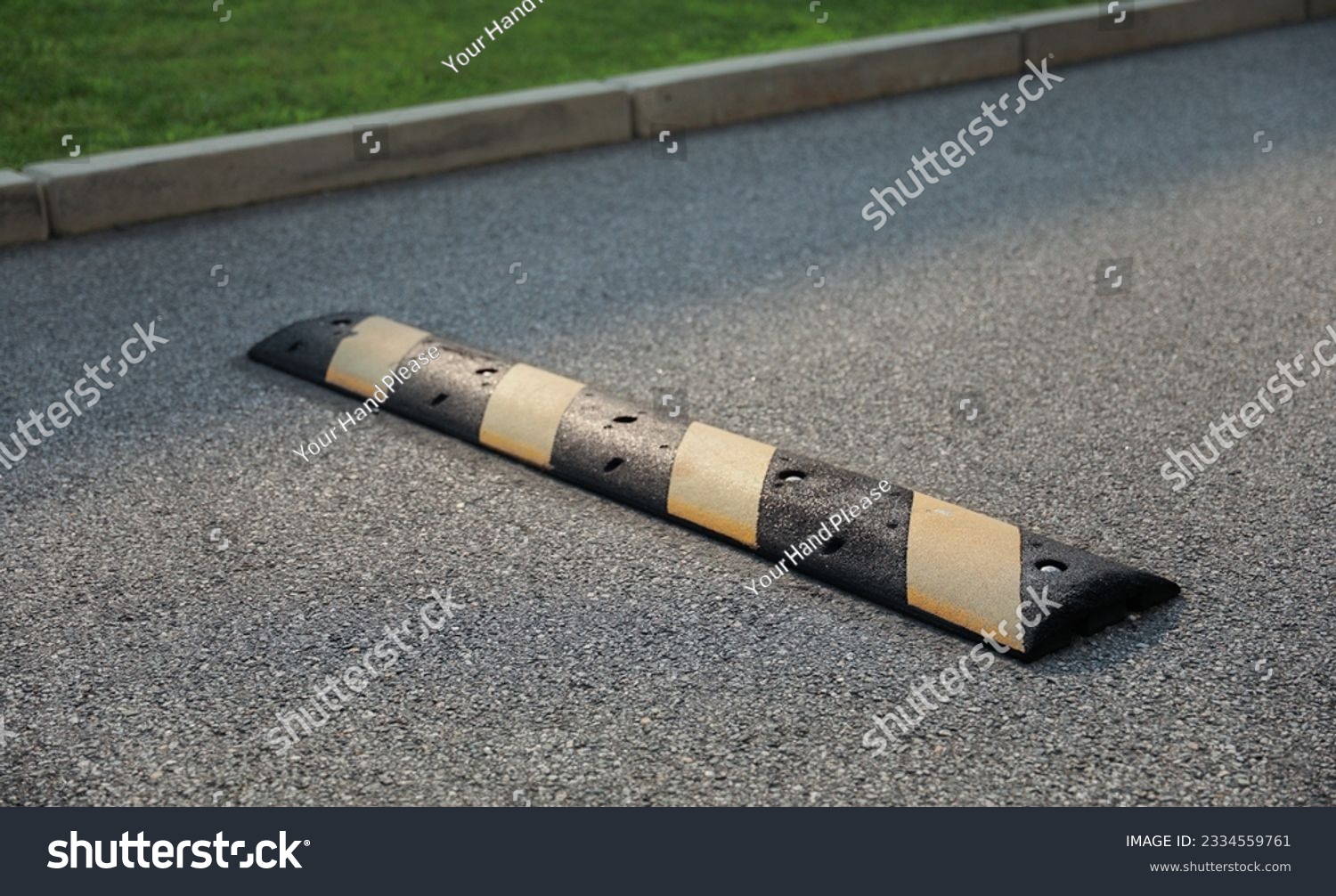 speed bump on a street symbolizes traffic control, caution, and slowing down for safety. It represents the need to be vigilant and considerate of others #2334559761