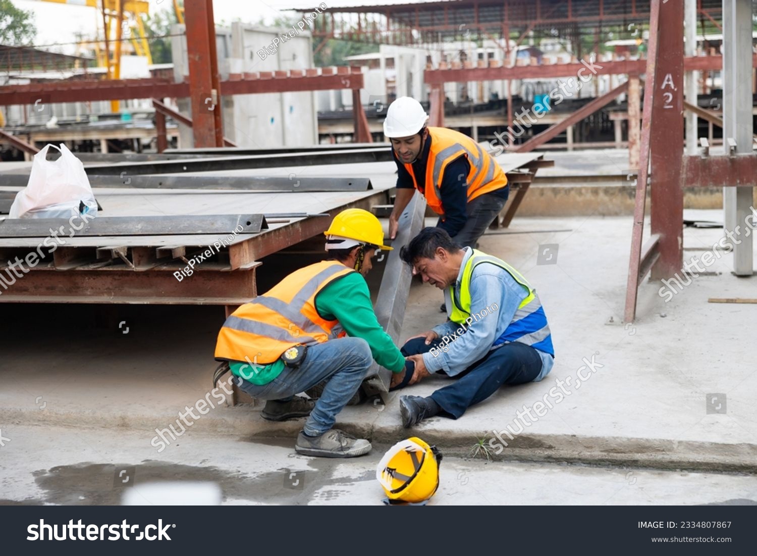 First Aid and safety first concept. Professional engineering teamwork concept. Engineering supervisor helping his coworker lying unconscious at industrial factory. Professional engineering teamwork  #2334807867