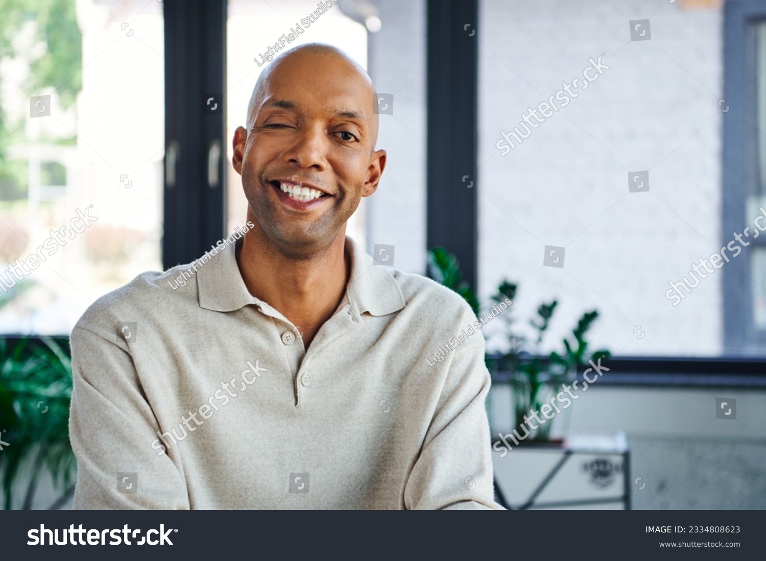 professional headshots, cheerful dark skinned man with myasthenia gravis disease looking at camera, happy office worker with eye syndrome, inclusion and diversity #2334808623