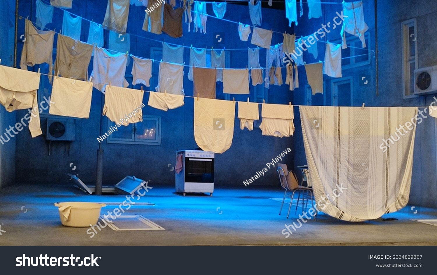 theater scenery on the stage, white bed linen being dried on clothesline, art. High quality photo #2334829307
