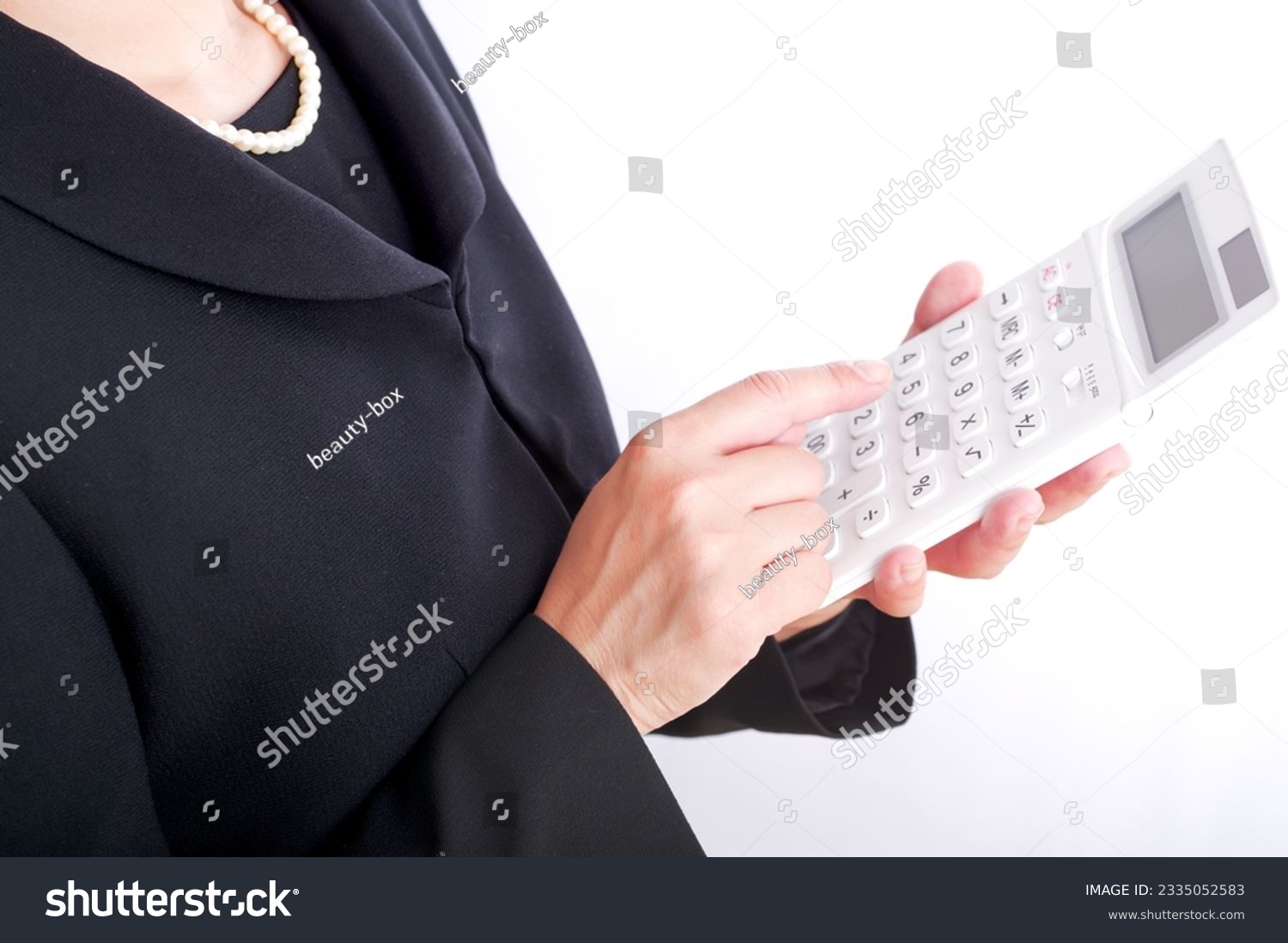 A woman in mourning clothes with a calculator #2335052583