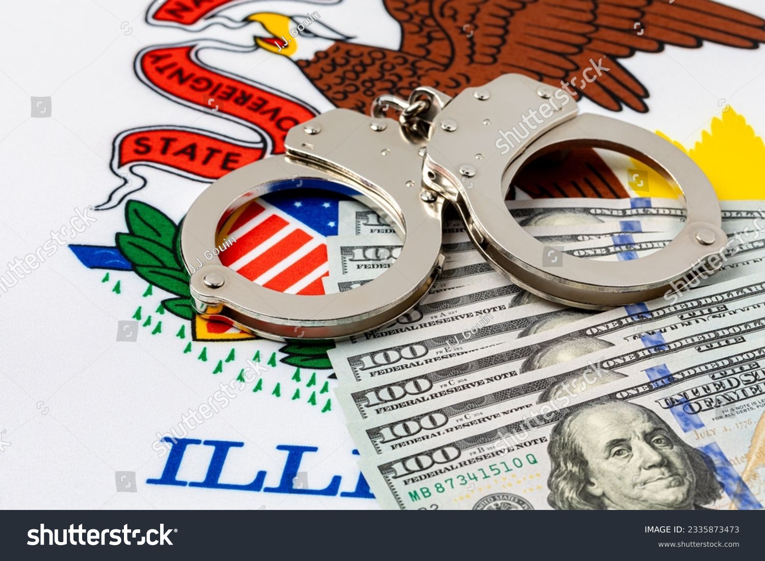 Handcuffs with cash money and Illinois state flag. Cash bail reform, bail bond and cashless bail concept. #2335873473