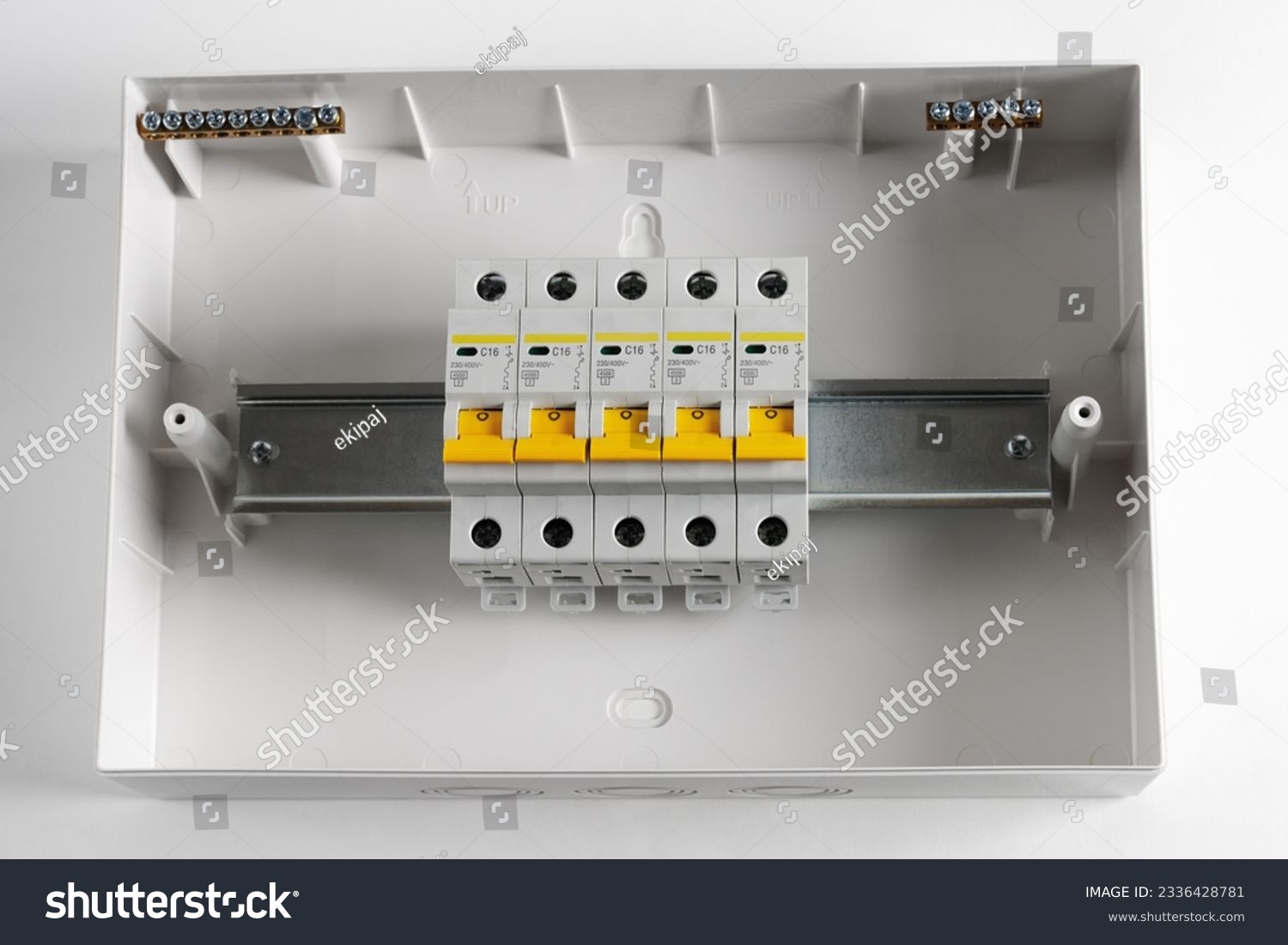 Plastic distribution board. Electrical board. Close-up. Isolated on light gray background. #2336428781