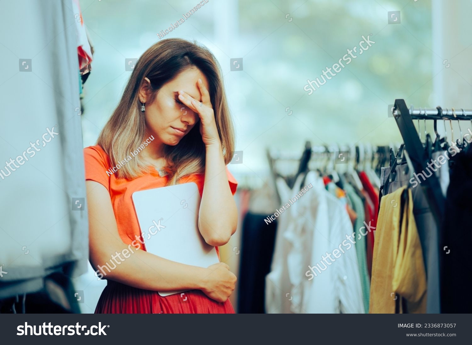 
Unhappy Store manager Holding a PC Tablet feeling Depressed. Sad business owner failing having to declare bankruptcy 
 #2336873057