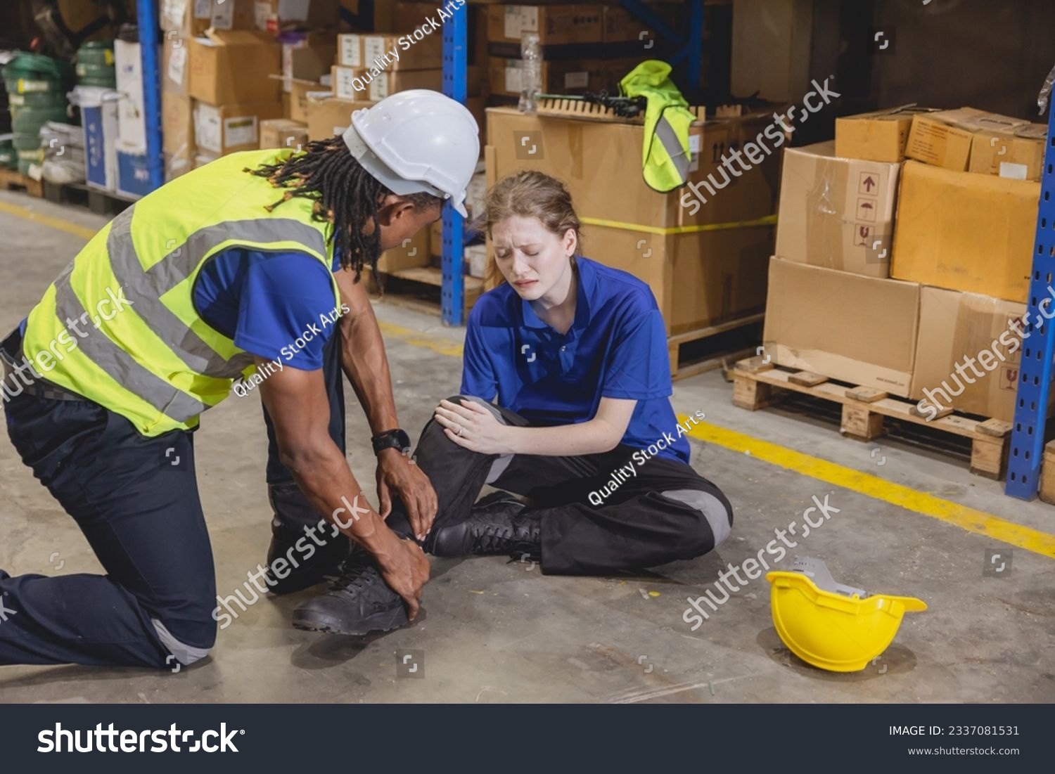 young woman warehouse worker accident leg injury slip and fall ankle sprain friend help support #2337081531