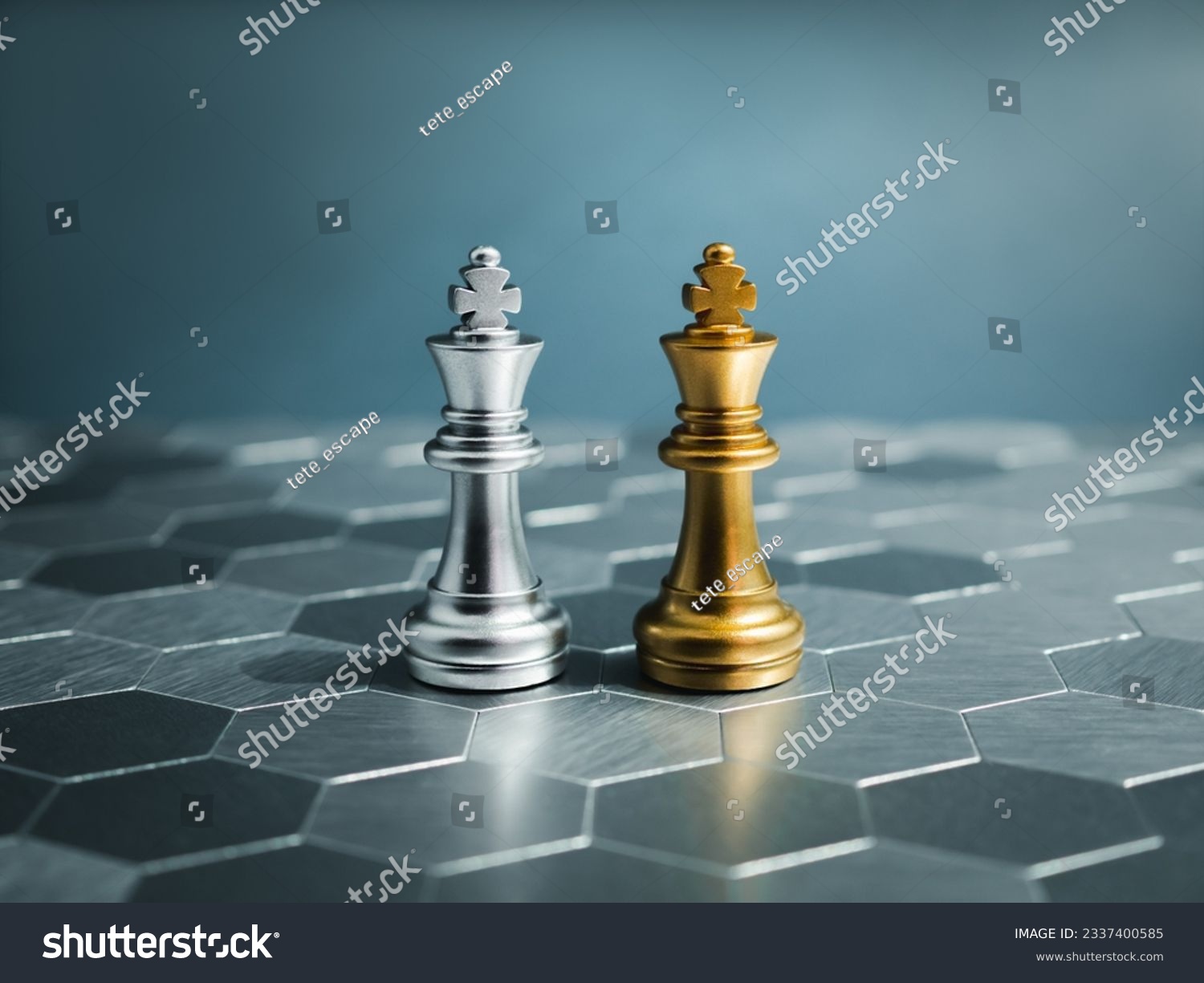 Golden and silver king, luxury chess pieces standing together on a silver hexagon pattern chessboard on blue background. Leader, friend, enemy, cooperation, partnership, and business strategy concept. #2337400585