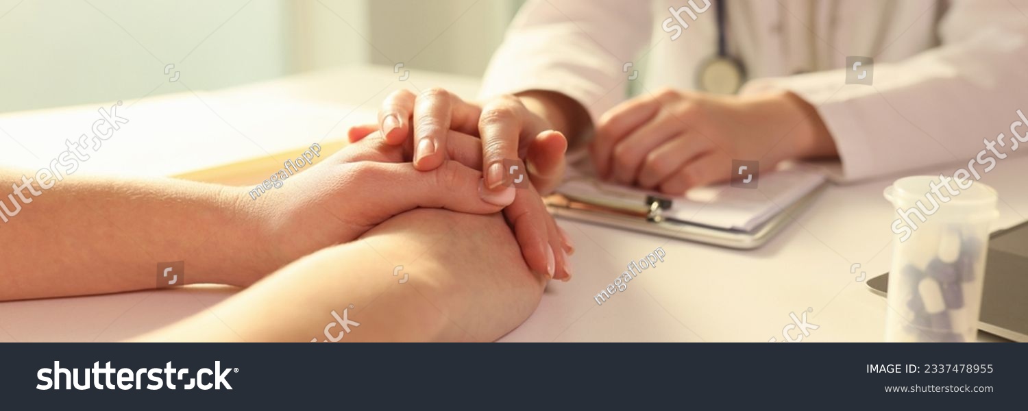 Doctor with his hand calming patient in clinic closeup. Psychological support for incurable patients concept #2337478955