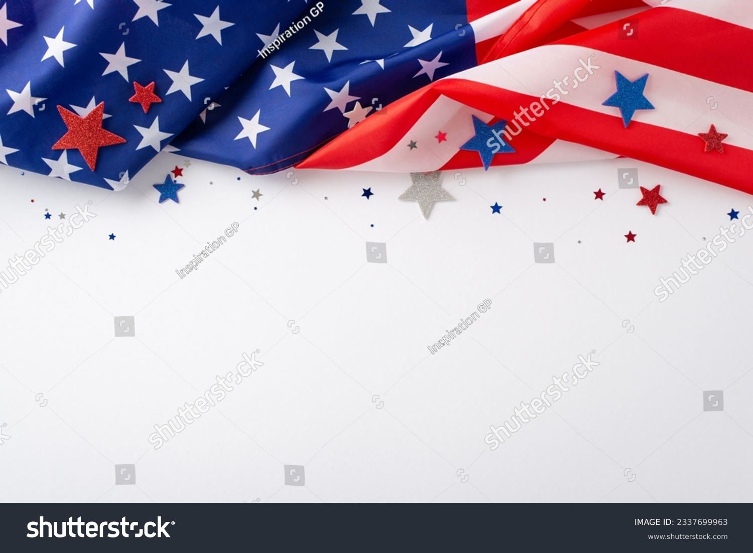 Festive mood of the public holiday: An evocative overhead composition displaying the American flag confetti stars on white backdrop. Ideal for advertisements or text placement during the occasion #2337699963