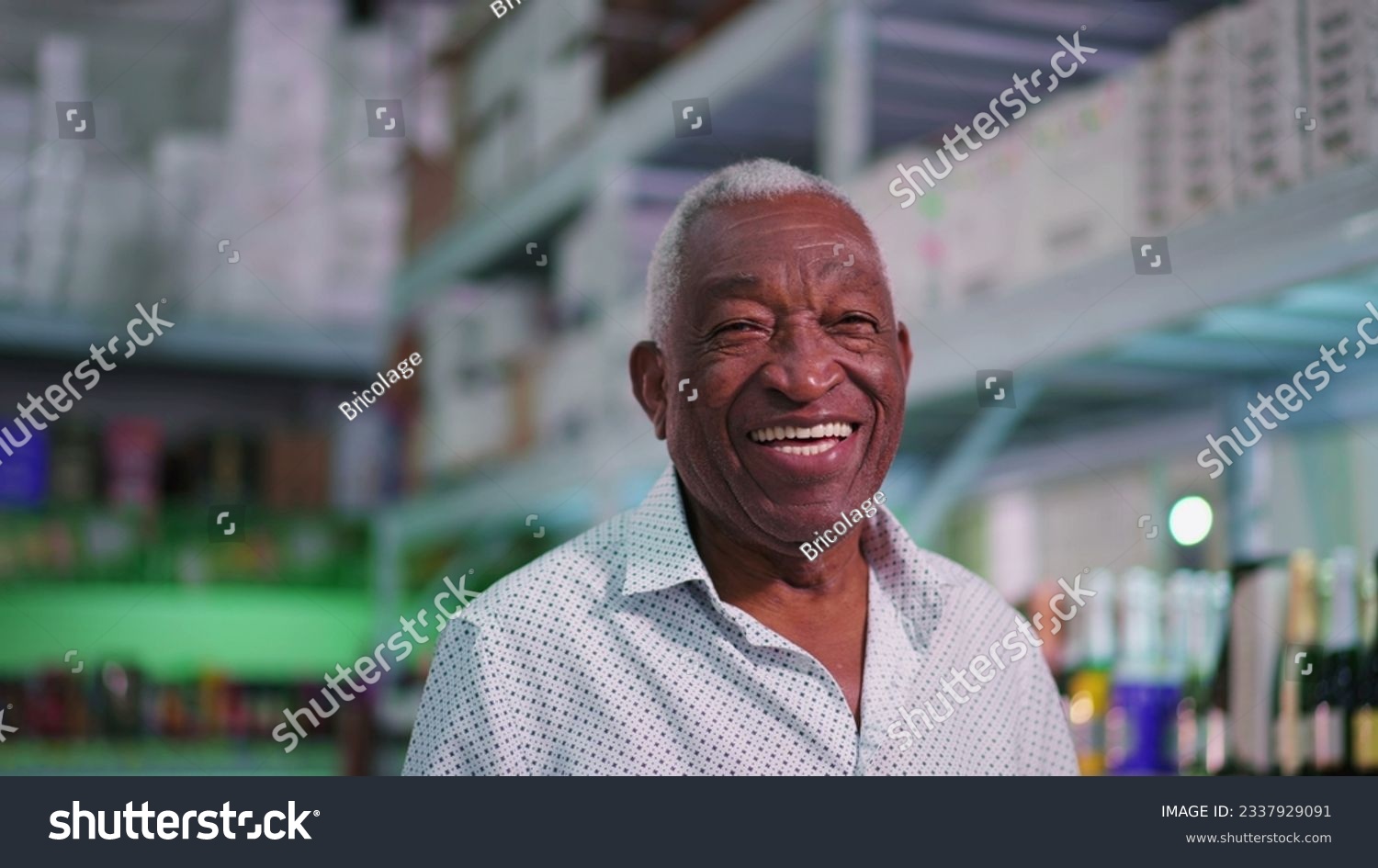 Portrait of a joyful Black Senior Brazilian man smiling at camera standing inside supermarket laughing #2337929091