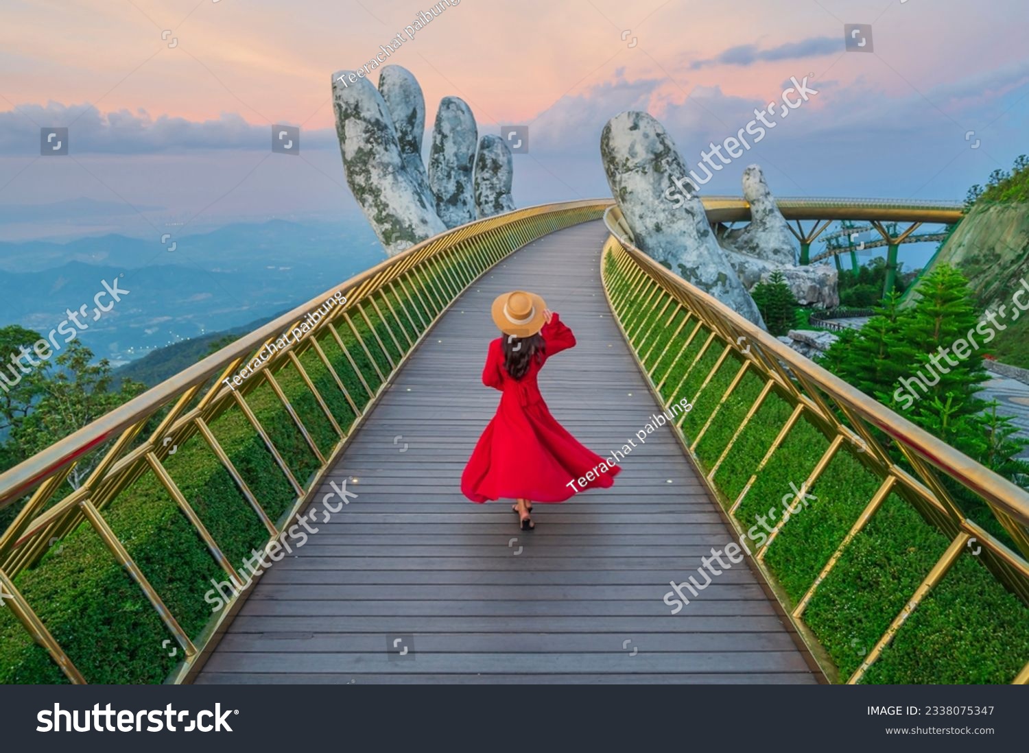 Young woman traveler in red dress enjoying at Golden Bridge in Bana hills, Danang Vietnam, Travel lifestyle concept #2338075347