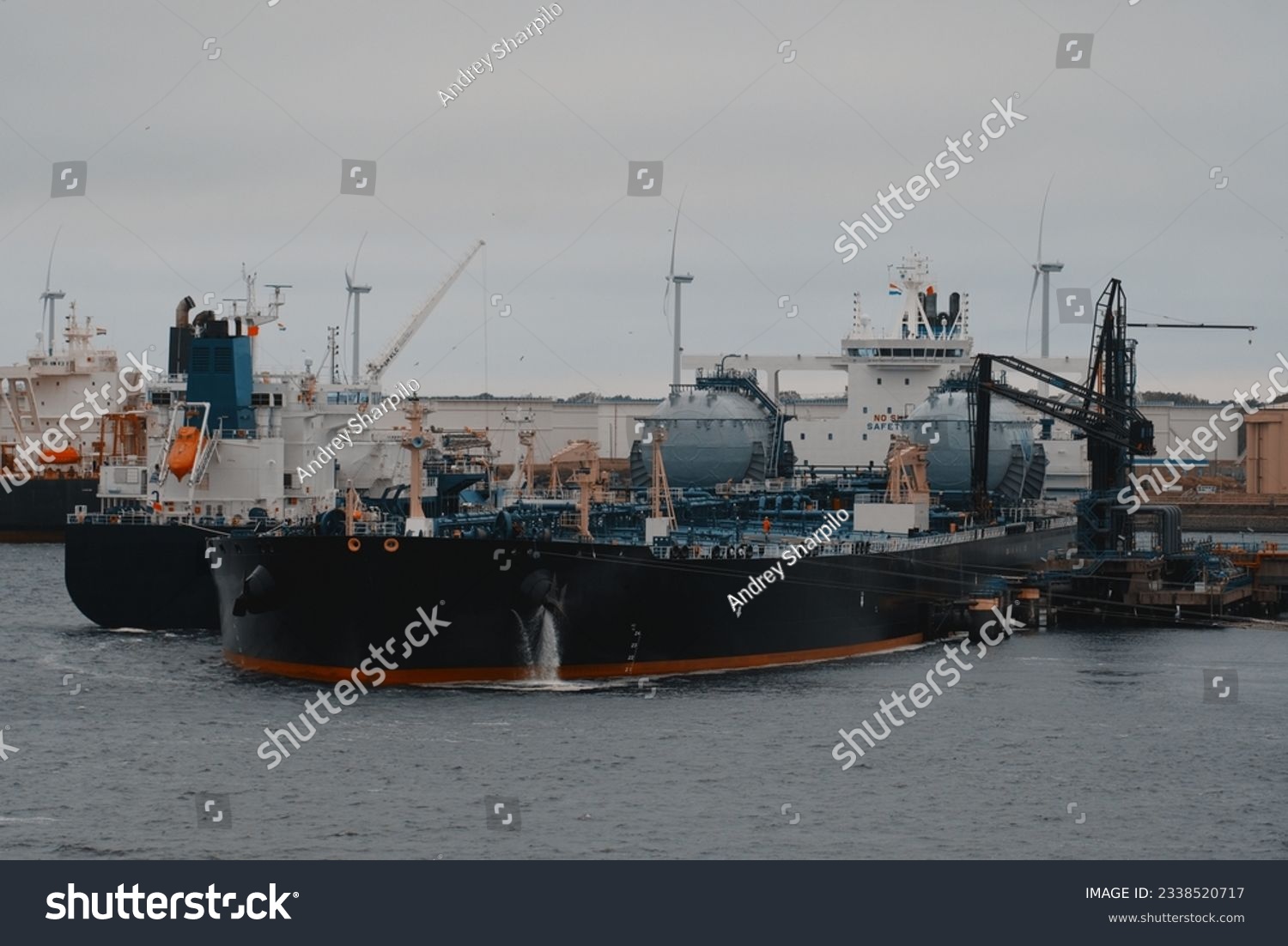 Floating storage and regasification unit. Liquified natural gas bunkering vessel and oil tanker powered by LNG in the port during the ship-to-ship operations. #2338520717