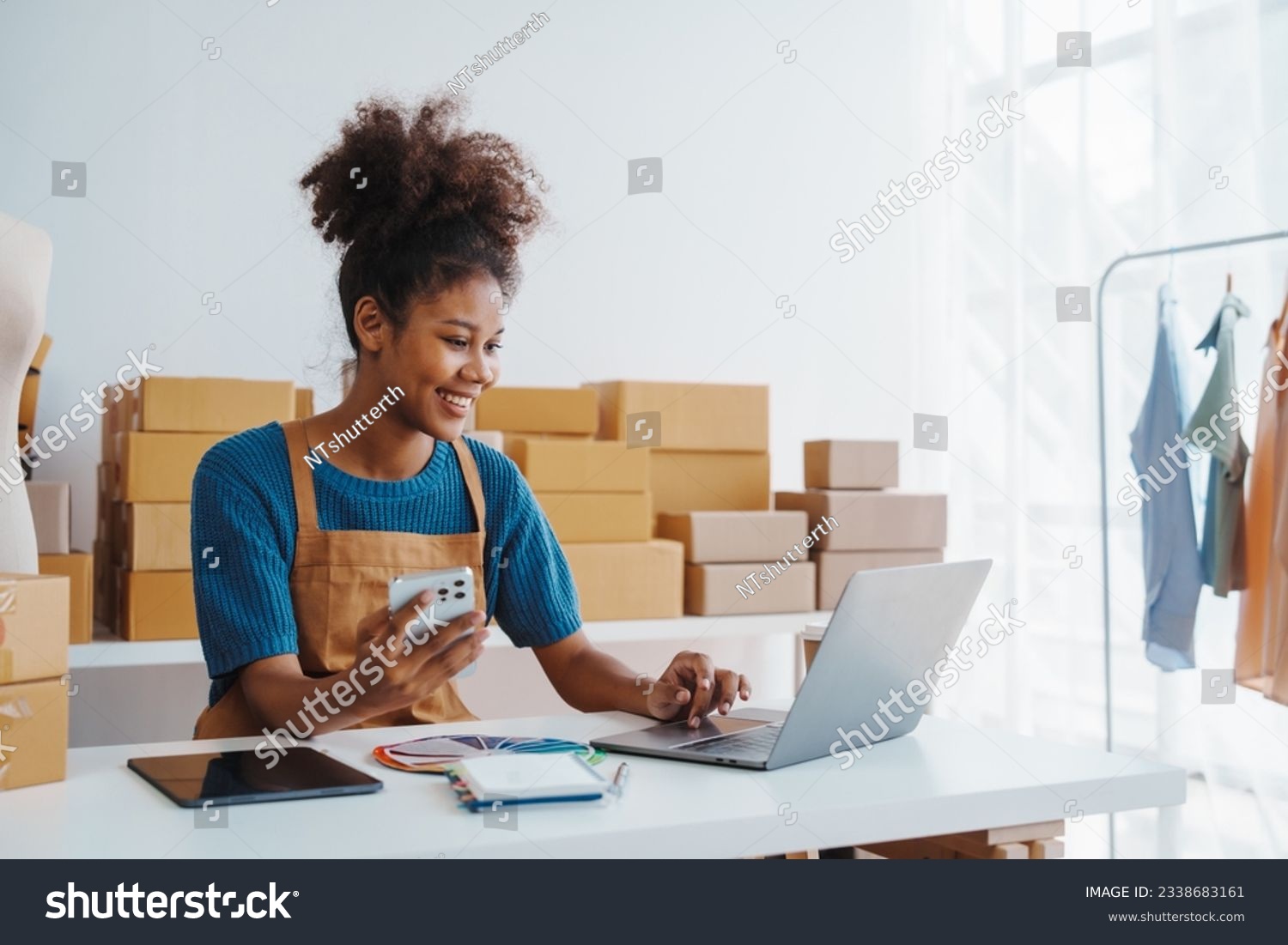 Pretty African American sme business woman working Custom Ecommerce Packaging leading supplier of custom packaging. create a personalised experience, fast production and competitive pricing #2338683161