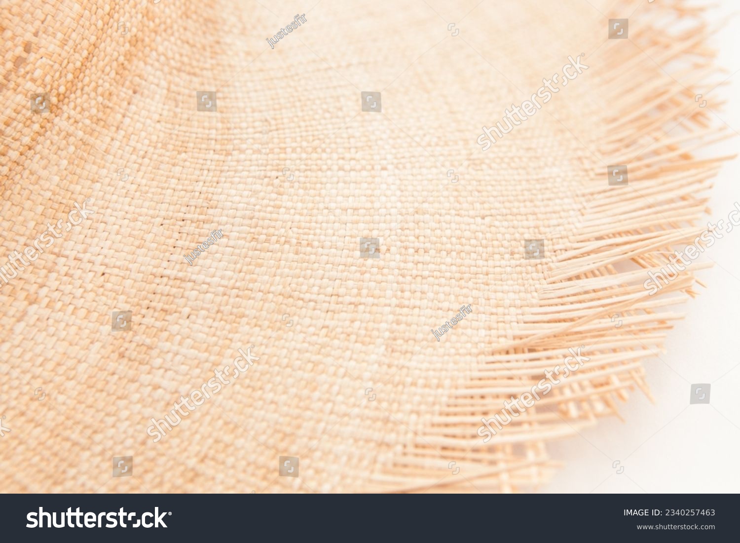 Light straw wicker hat as abstract summer fashion accessory background on white color #2340257463
