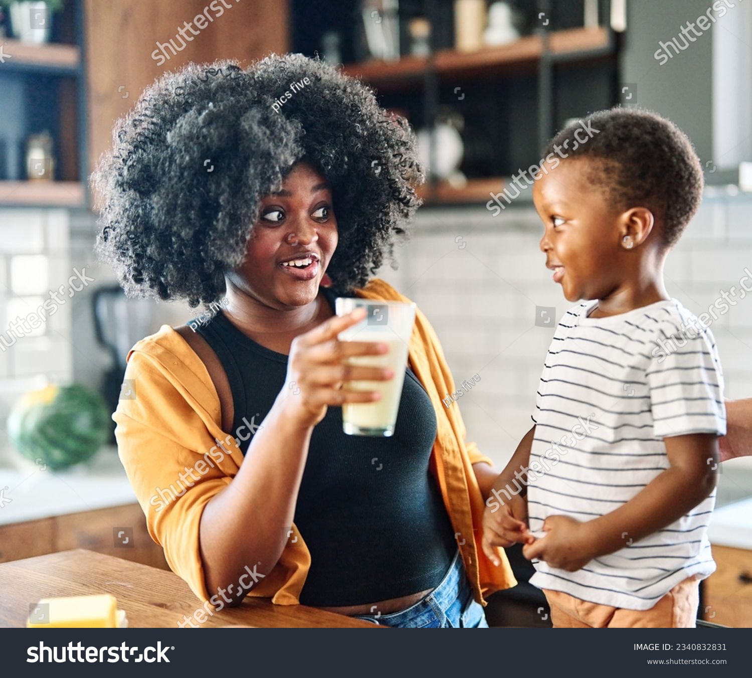 Portrait of mother, father and son  preparing and eating breakfast and drinking milk  in the kitchen at home #2340832831