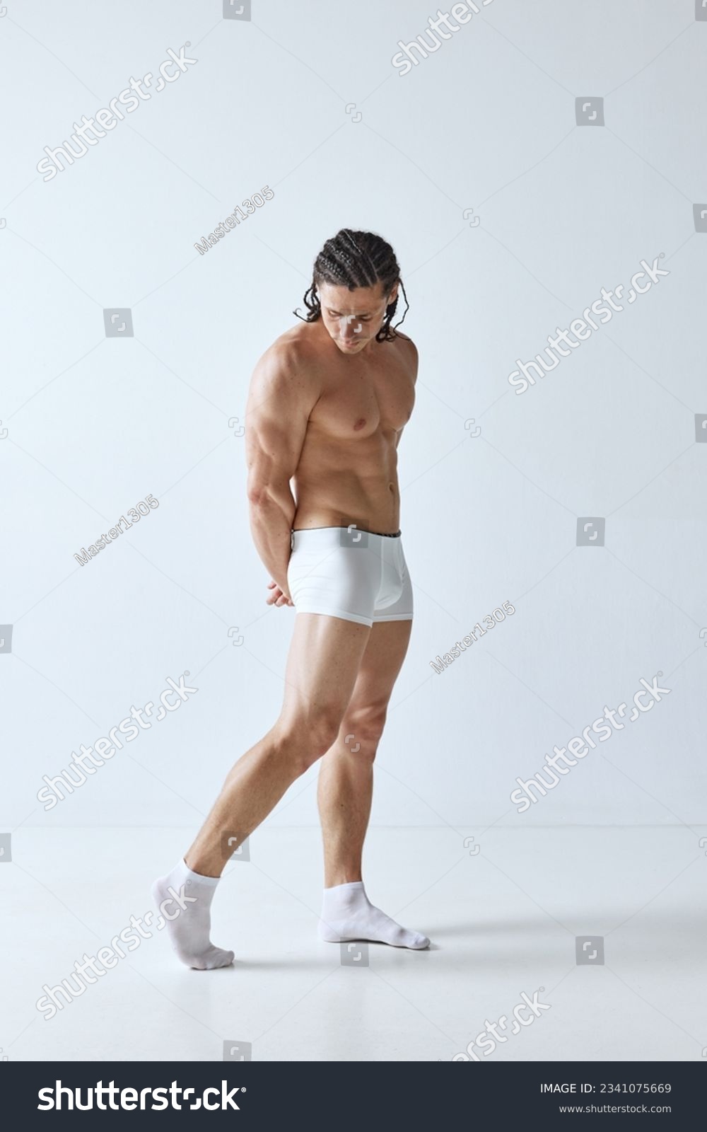 Full-length portrait of handsome mature man with muscular strong body standing shirtless in boxers against grey background. Concept of men's beauty, body care, sport, wellness, healthy lifestyle, ad #2341075669