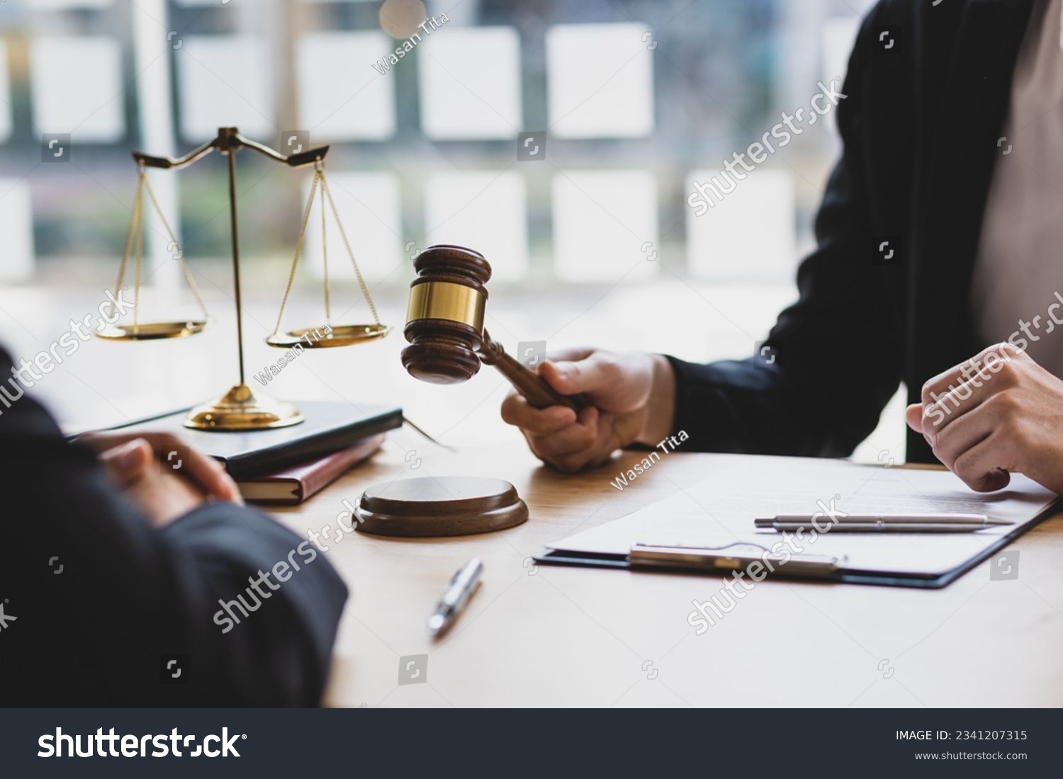 Lawyer is explaining the terms of the legal contract document and asking the client to sign it properly. Legal counsel and legal proceedings consulting services. #2341207315