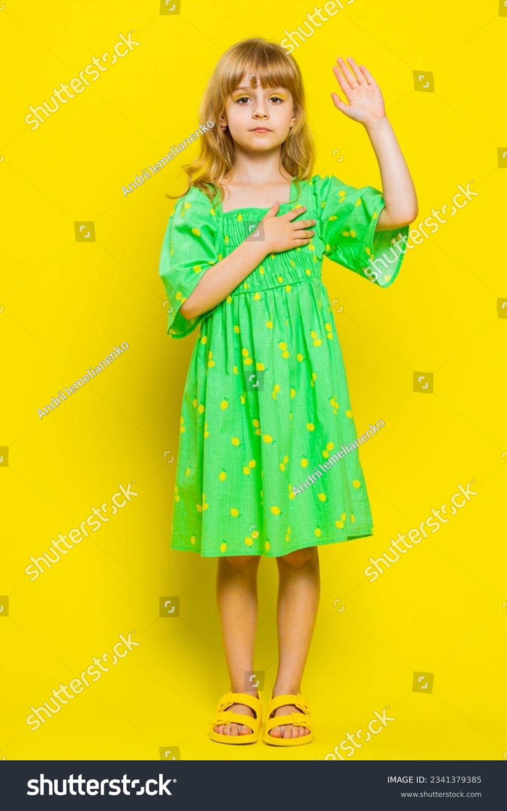 I swear to be honest. Sincere responsible child girl kid raising hand to take oath, promising to be honest tell truth be polite, keeping hand on chest. Preteen children on yellow background. Vertical #2341379385