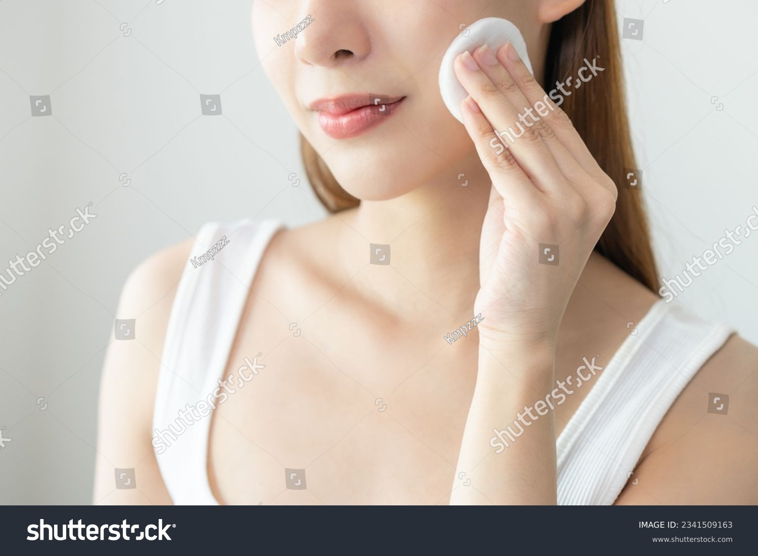 Happy beauty, attractive asian young woman, girl looking camera hand holding cotton pad, applying facial wipe on her face remover makeup, essence or lotion of skin care. Isolated on white background. #2341509163