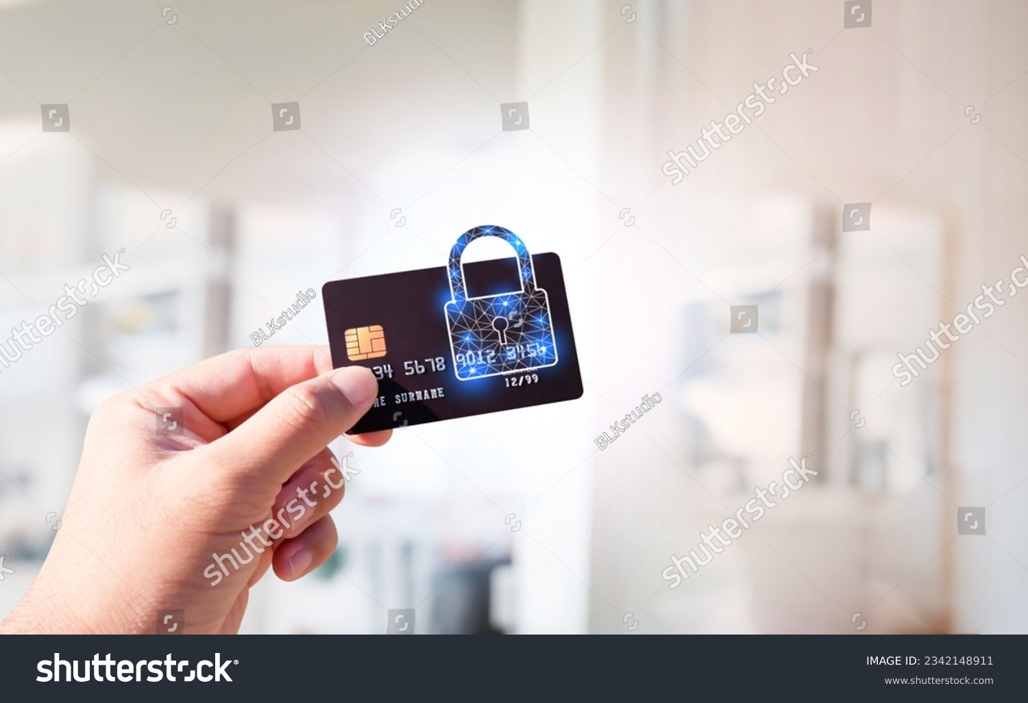 Close up of man hand holding credit or debit card with padlock, protection of financial transactions, copy space, Financial security technology concept. #2342148911