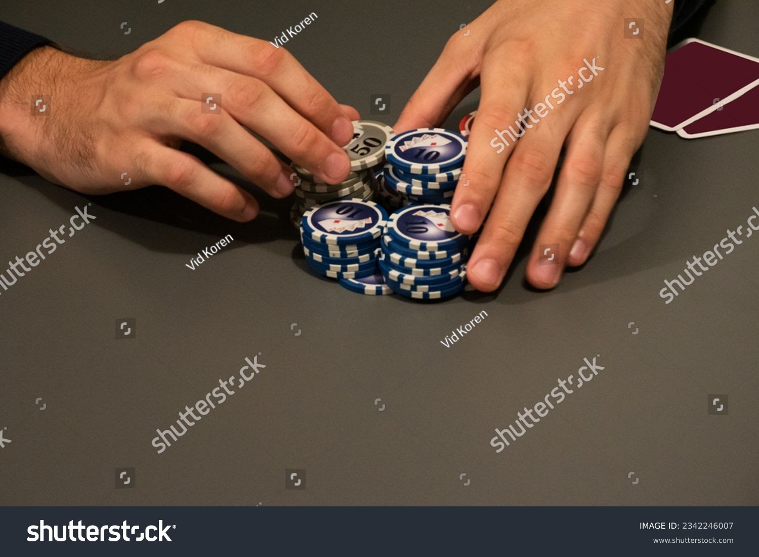 Man pushing poker chips for all-in. Picture without a face.  #2342246007