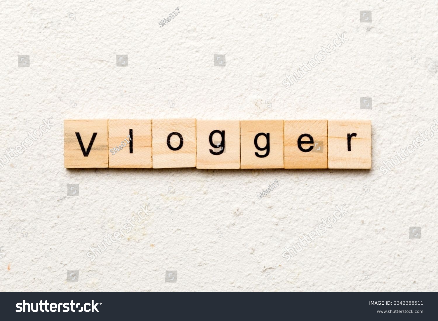 vlogger word written on wood block. vlogger text on table, concept. #2342388511
