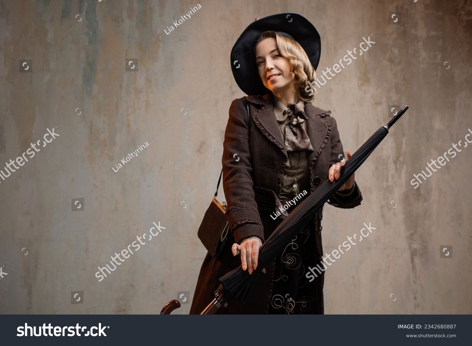 A stylish lady in an elegant Victorian-style suit, wearing a hat with an umbrella in her hands #2342680887