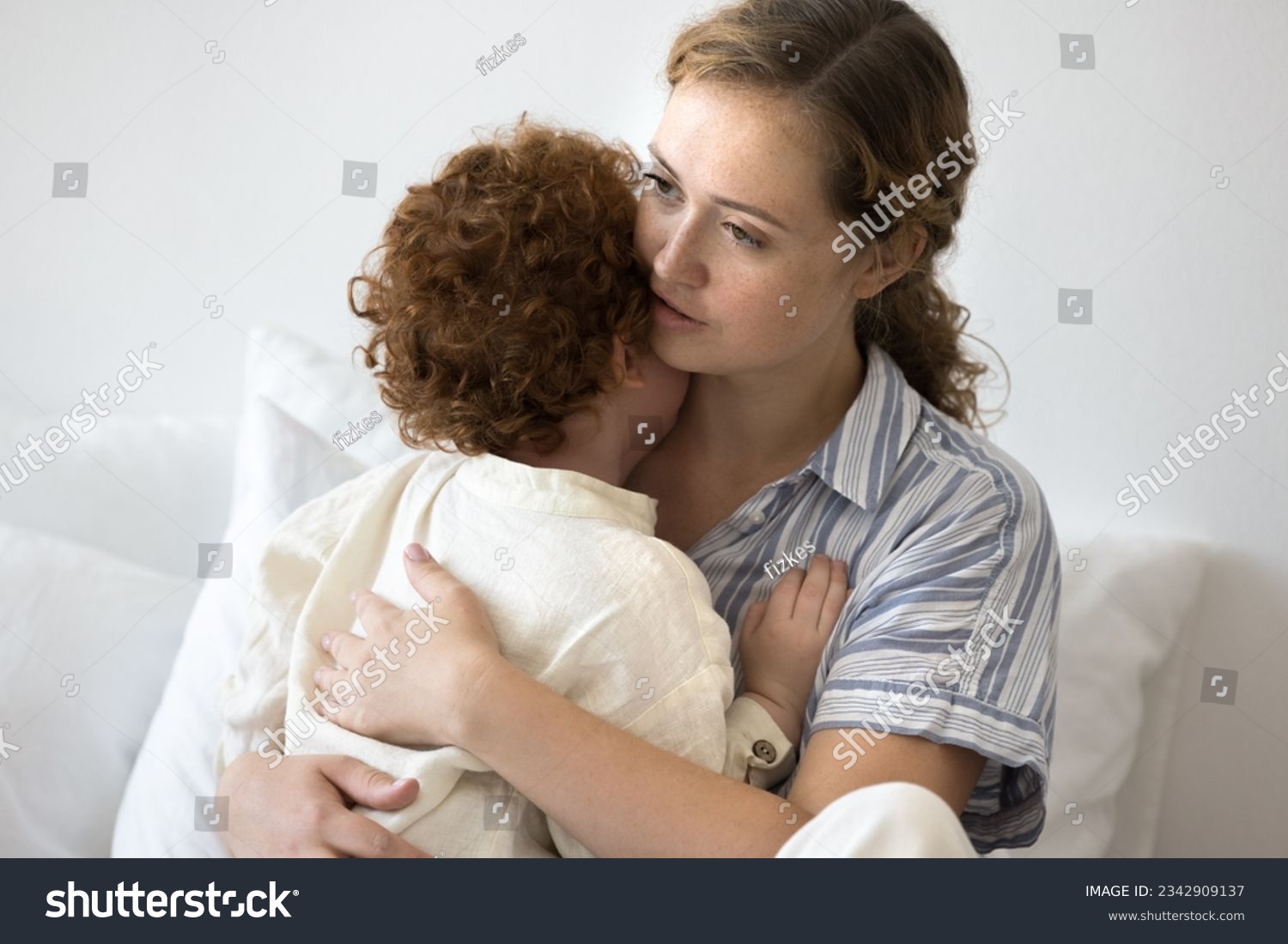 Caring young mom comforting crying toddler child, hugging little kid, holding in arms, giving support, love. Mother embracing little kid, enjoying motherhood, parenthood #2342909137