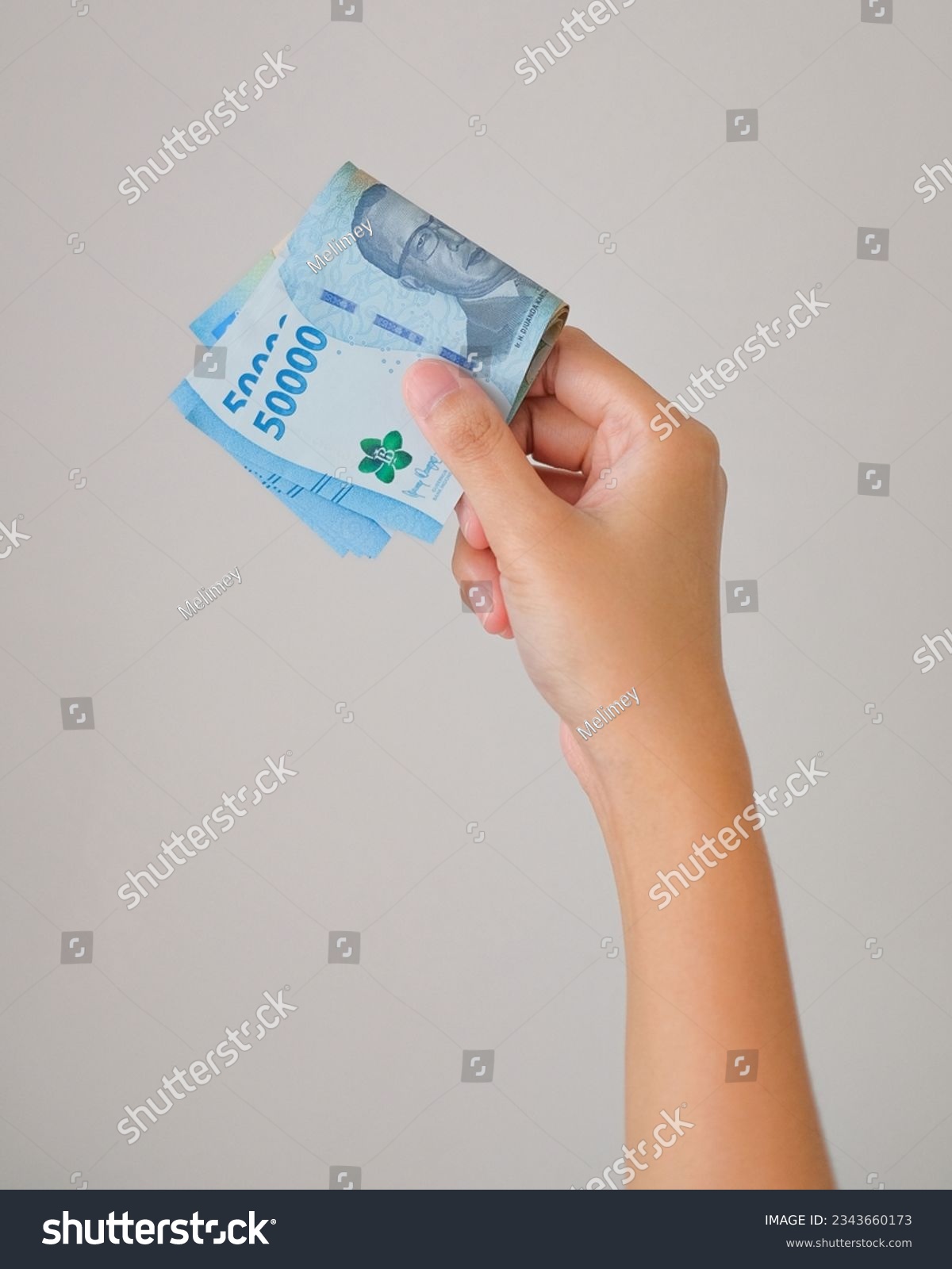 Woman Hand Hold New Rupiah Indonesian Money 2023 #2343660173