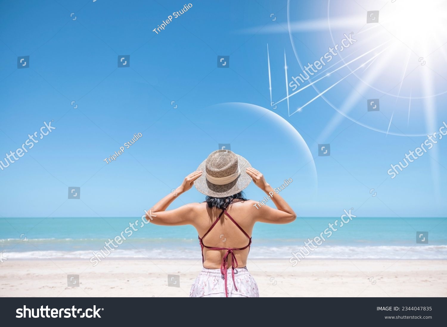 Asian model wear red swimsuit and straw hat stand on beach look view on hot day, Sun and UV rays hit the beautiful woman's protective layer. concept about of spa, sunscreen, cosmetics, health. #2344047835