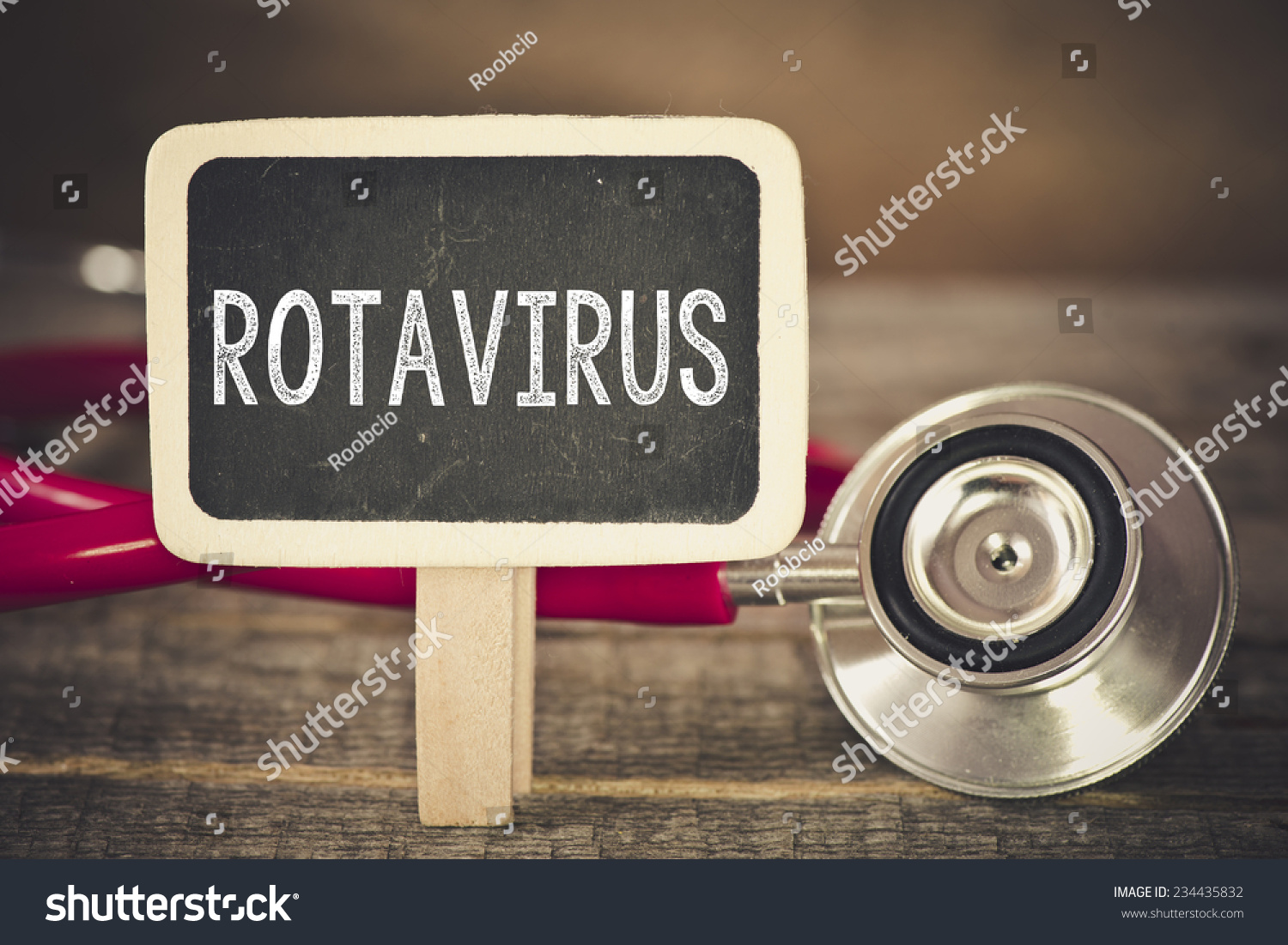 Rotavirus and stethoscope. Medecine concept. Blackboard with word rotavirus and stethoscope #234435832