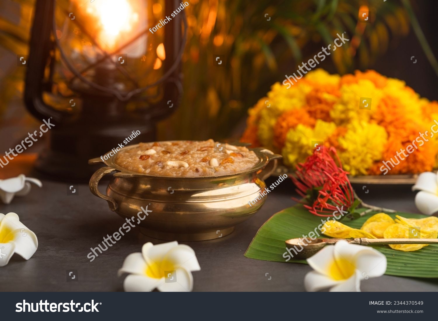 Temple Payasam Ari payasam or sarkara payasam in a golden uruli with flowers on the background, Onam sadhya special food #2344370549