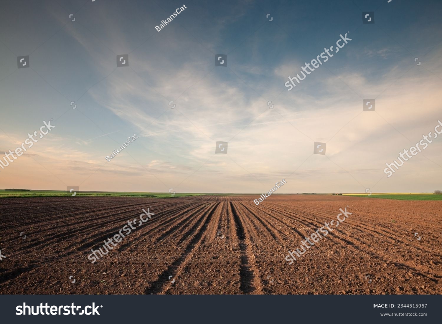 Selective blur on furrows on a Agricultural landscape near a farm, a plowed field in the countryside of Titelski, Serbia, Voivodina. The plough is a technique used in agriculture to fertilize a land. #2344515967