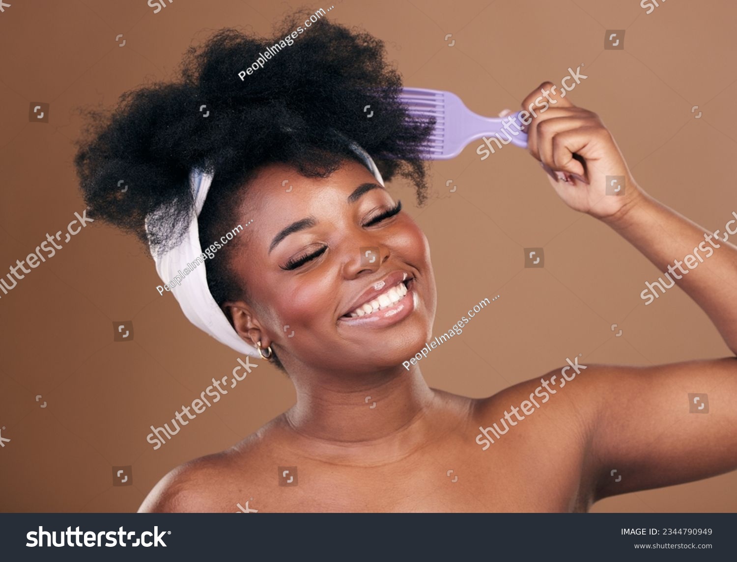 Comb, hair care or happy black woman with afro, self love or smile on a brown studio background. Hairstyle, healthy growth or African model with natural shine or beauty with aesthetic or wellness #2344790949