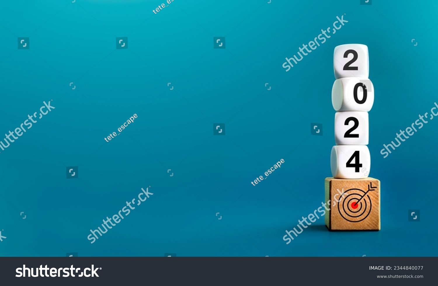 2024 Happy New year background banner. Numbers on white dices on target icon on wooden cube blocks stacked on blue background with copy space. Welcome, Merry Christmas, and Happy New Year in 2024. #2344840077