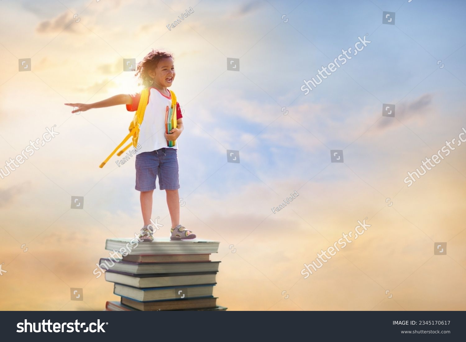 Children go back to school. Start of new school year after summer vacation. Boy with backpack and books on pile of books on first school day. Beginning of class. Education for preschool kids. #2345170617