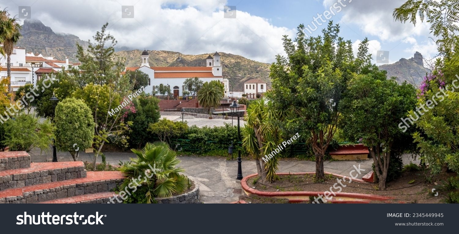 Panoramic photograph from a park in Tejeda, one of the most beautiful towns in Spain. In the center the Church and in the background to the left Roque Bentayga and to the right Roque Nublo. Gran Canar #2345449945
