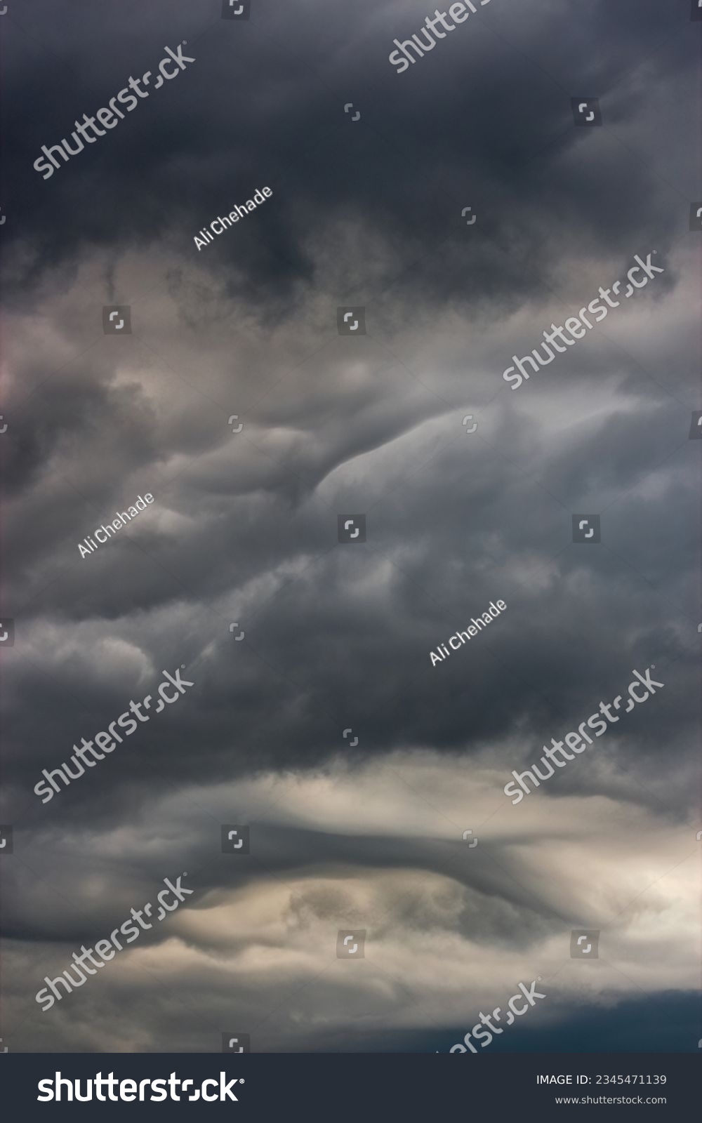 Dark clouds in the sky during a storm. The clouds are ominous and foreboding, and they are a sign of bad weather to come. #2345471139