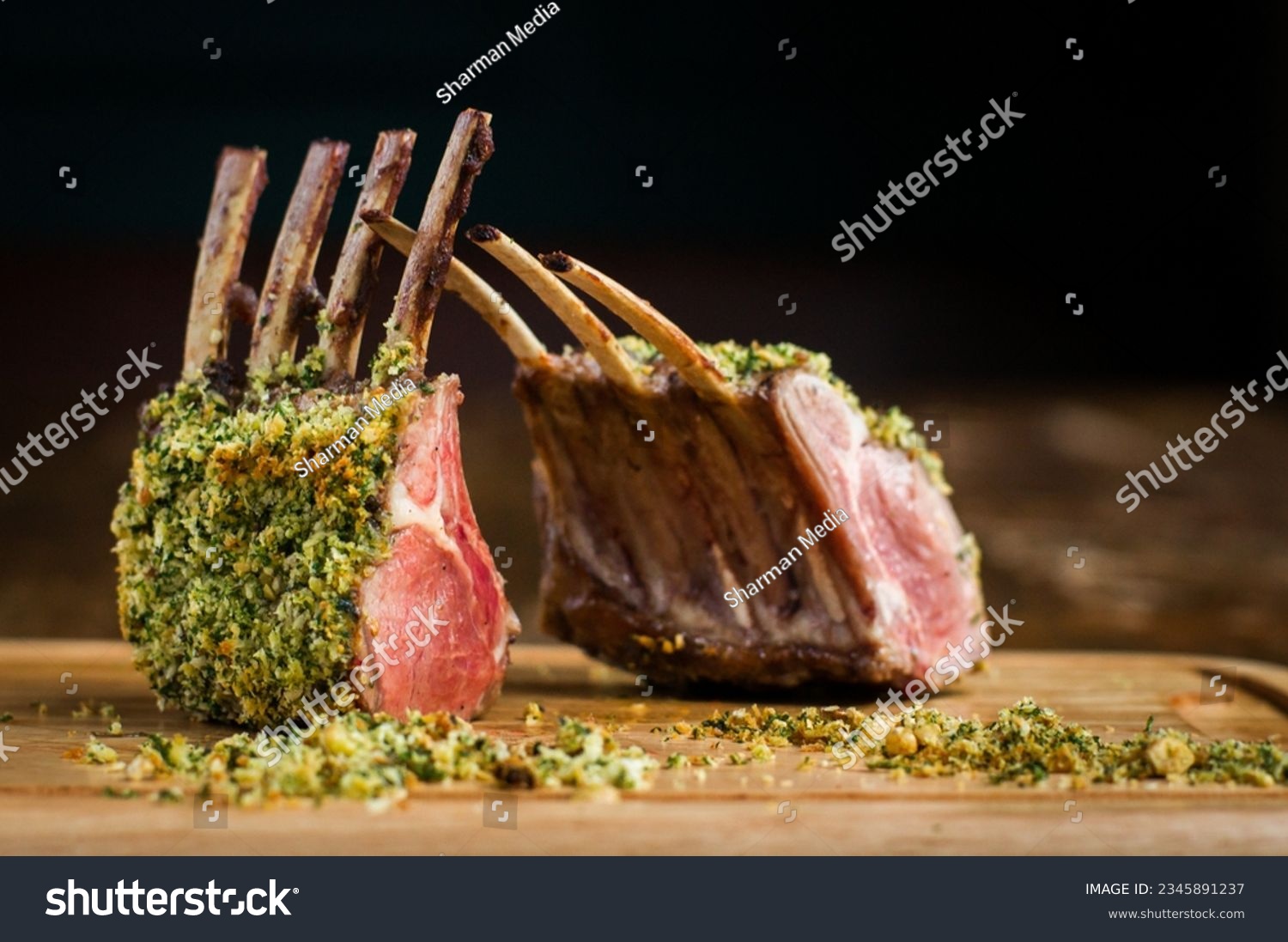 Rack of lamb with hazelnut herb crust on wooden board in restaurant #2345891237