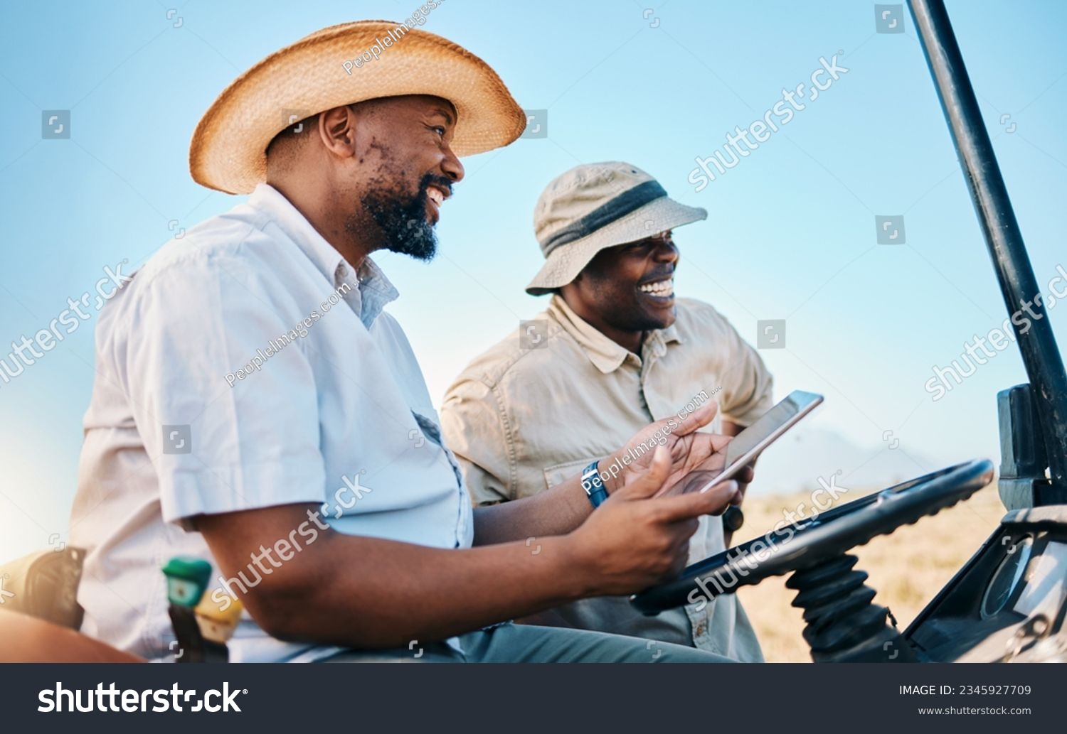 Game drive, safari and men laugh with tablet for direction in Kenya desert with car for travel transport. Holiday, tour guide and driving with tech for adventure, holiday and journey with employees #2345927709