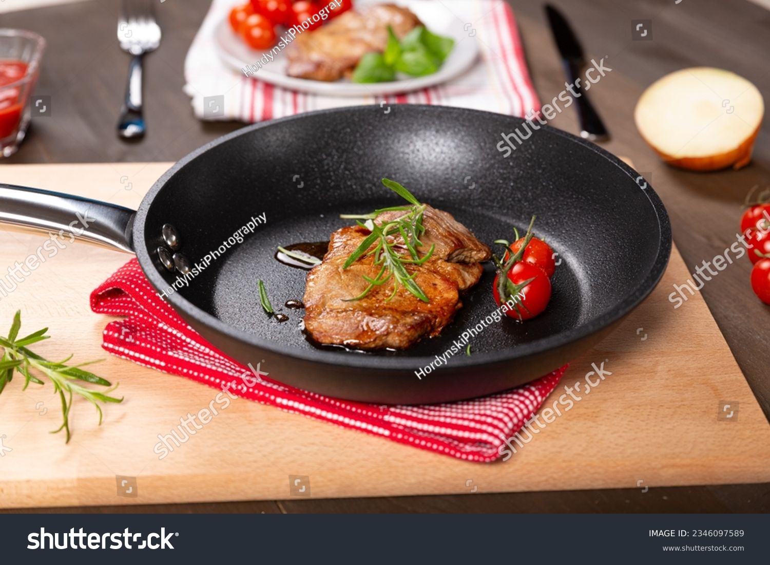 Pork neck steak in a teflon pan #2346097589