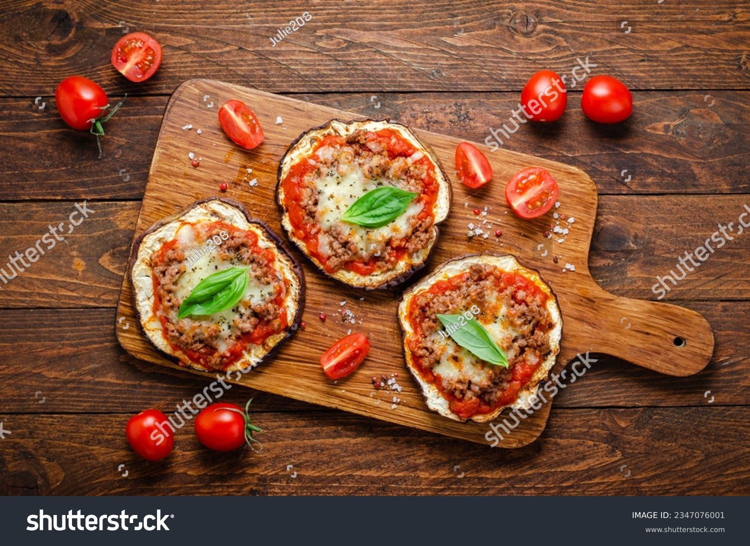 Eggplant Pizza with Tomato Sauce, Minced Meat, Mozzarella and Basil, Mini Pizza over Rustic Background #2347076001