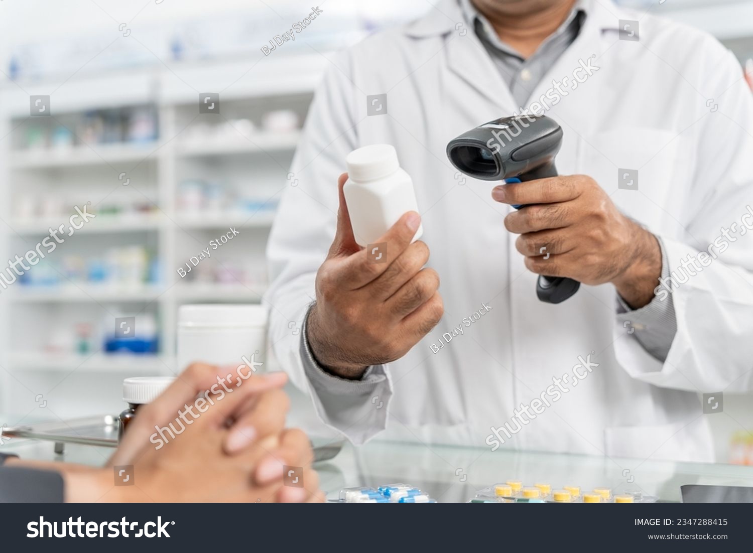 Close up hands of male pharmacist using barcode scanner for selling medicine to patient customer in the pharmacy drugstore, hand over capsule pills of medicine from hand to another hand charge. #2347288415