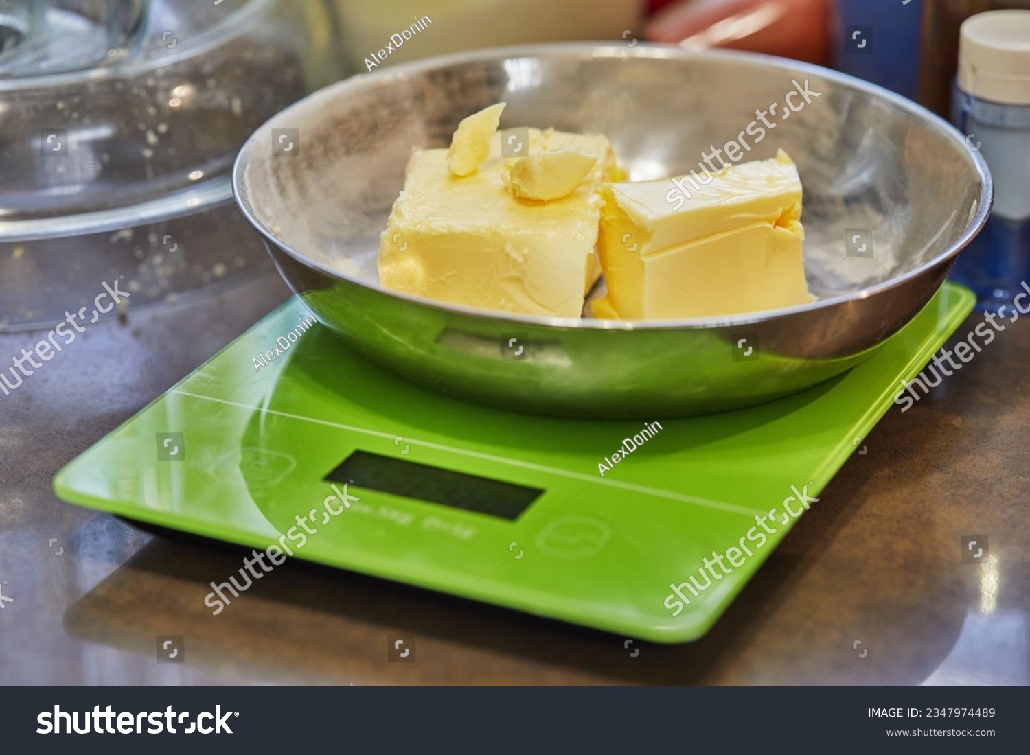 Butter in metal plate on digital scale in home kitchen. #2347974489