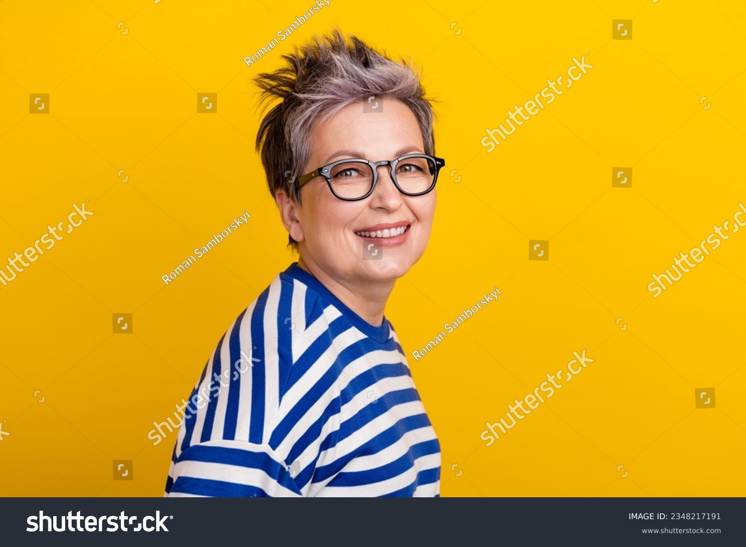 Portrait of young beautiful businesswoman striped blue pullover dyed short haircut lady posing magazine isolated on yellow color background #2348217191